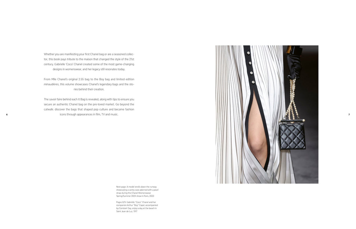 Black handbag with chain detail worn by a model against a white background
