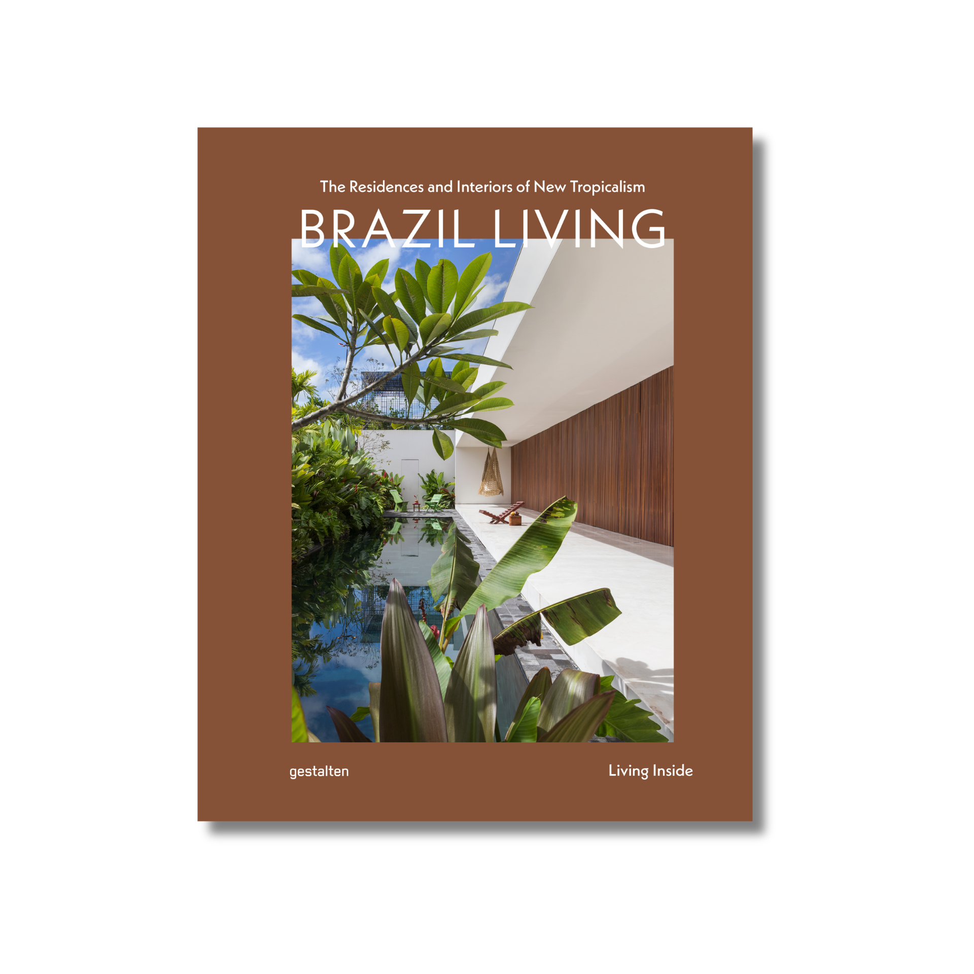 Book cover of 'Brazil Living' featuring a modern interior design with plants and a pool.