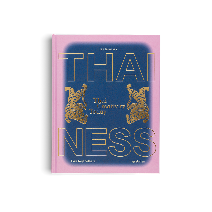 Book cover with 'THAI NESS' text and gold tiger illustrations on a pink and blue background