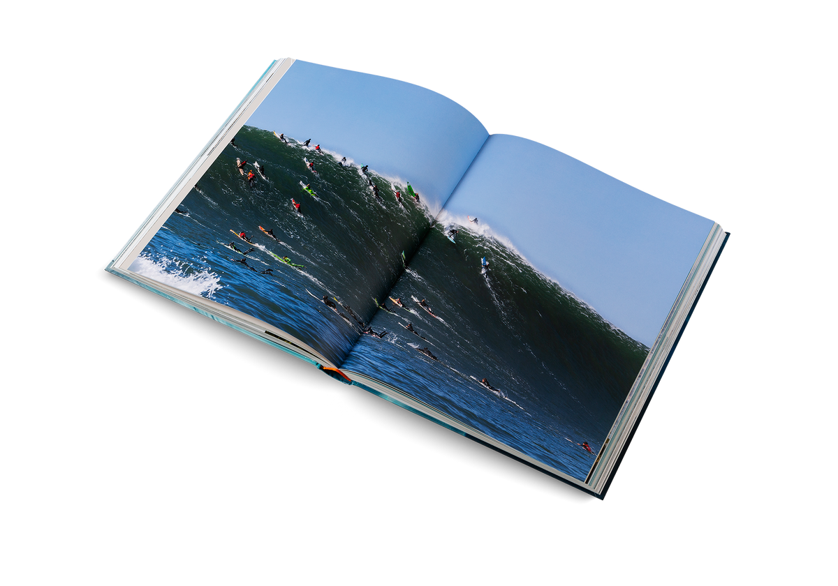 Surfers on a giant wave. Find out more about iconic surfing spots in The Surf Atlas by Luke Gartside.