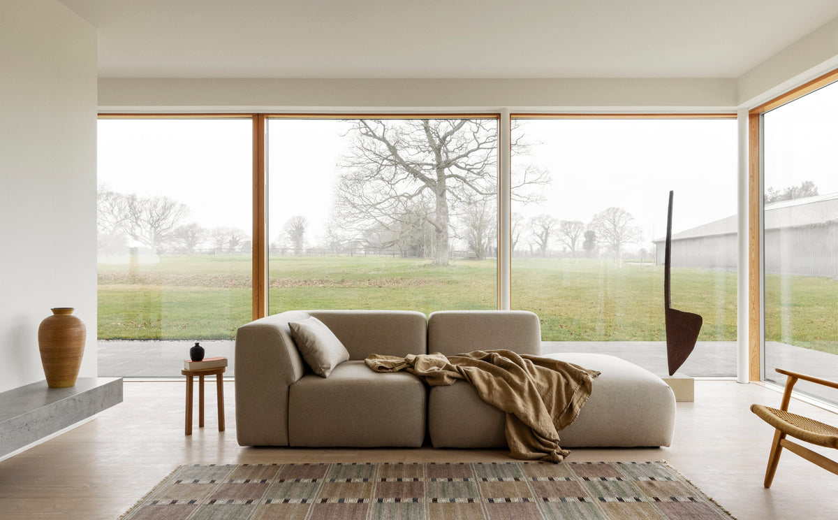 The long sightlines and full height windows—cut right down to the Dinesen floors—give the feeling of barely being inside at all. Nature is omnipresent. The incorporation of natural materials as artwork imbues the decidedly contemporary design with a comforting earthiness.