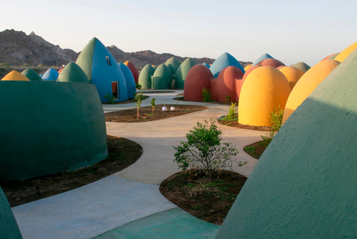Presence is a tourism complex built on the island of Hormuz, Iran, to stimulate the local economy and offer more autonomy to the community. The island is located on its namesake strait, which is the key passage for Middle Eastern petroleum exportation. It is a site of geological wonder, made up of colorful landscapes including an ochre-red beach and rainbow mountains. The Superadobe Domes of Hormuz by ZAV Architects in Iran are featured in The ArchDaily Guide to Good Architecture.