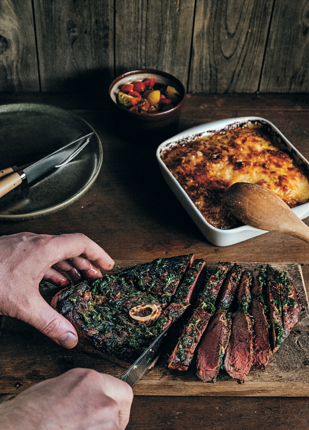 Flintastek is a marinated ham steak that first became popular in Sweden in the 1960s, but really took off in the 1980s when it was renamed after The Flintstones TV animated sitcom. These days, Swedes tend to associate the dish with cheap, pre-marinated meat badly cooked over a disposable grill. But if you make flintastek from wild boar and serve it with a fresh tomato salad, the flavor will reward your effort ten times over. The recipe of this Grilled wild boar ham steak is in The Wild Game Cookbook