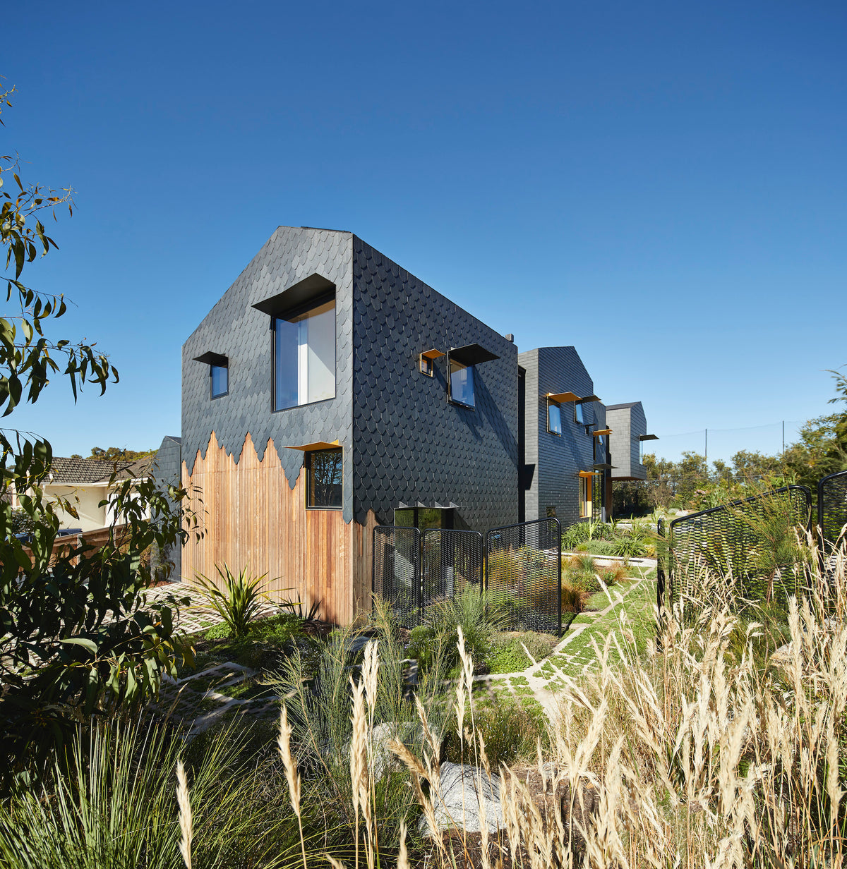 Charles House, with its contrasting shapes, angles, textures, and materials, is a distinct piece of residential architecture. The multigenerational home was designed for longevity for a family of five, plus grandparents, that they could live in for at least 25 years.