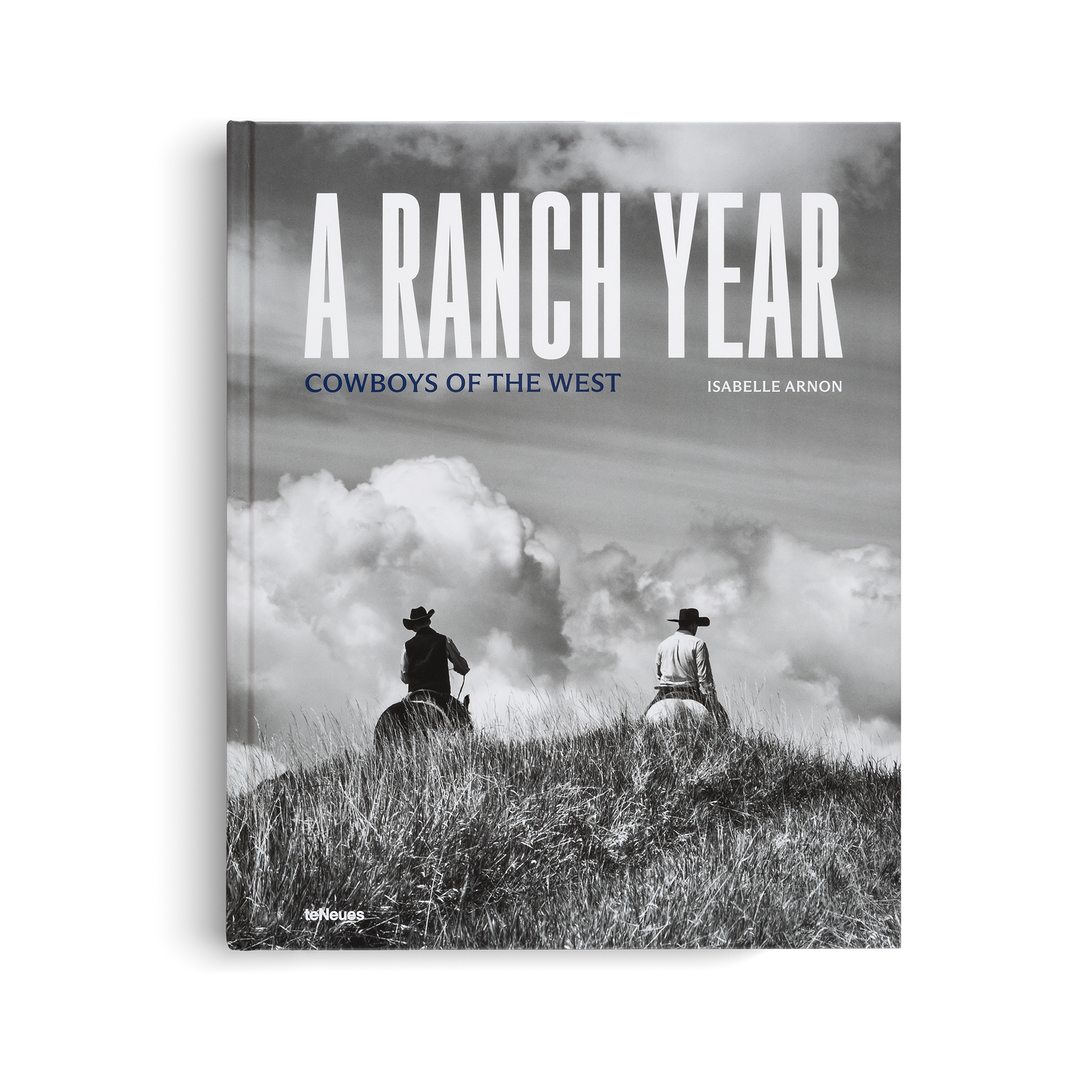 Book cover of 'A Ranch Year: Cowboys of the West' with two cowboys on horseback against a cloudy sky.