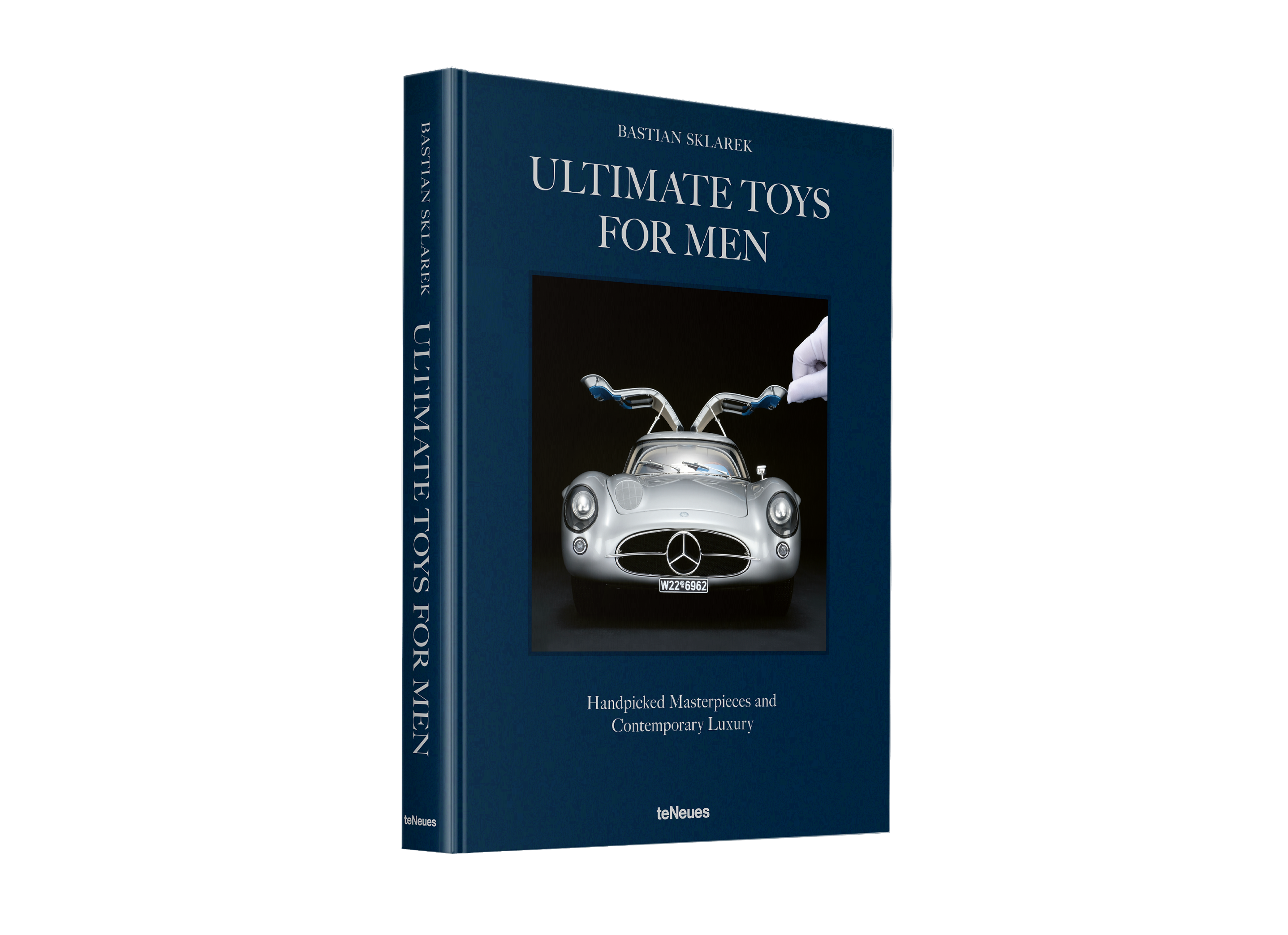 Book titled 'Ultimate Toys for Men' with a cover featuring a classic car.