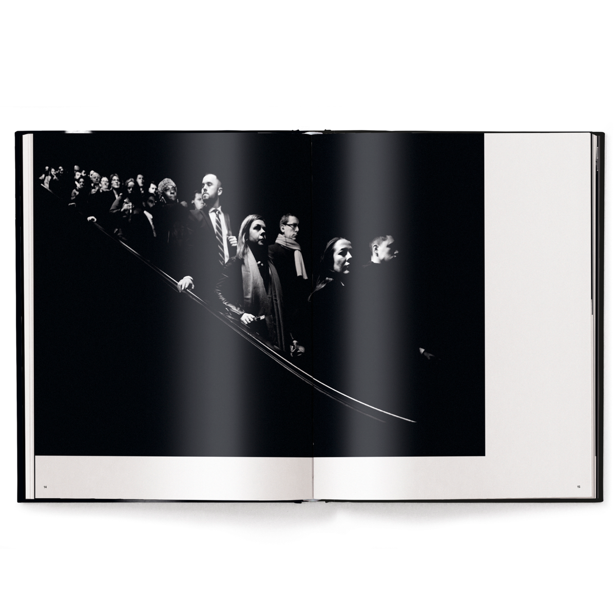 Open book showing a black and white photograph of a crowd.