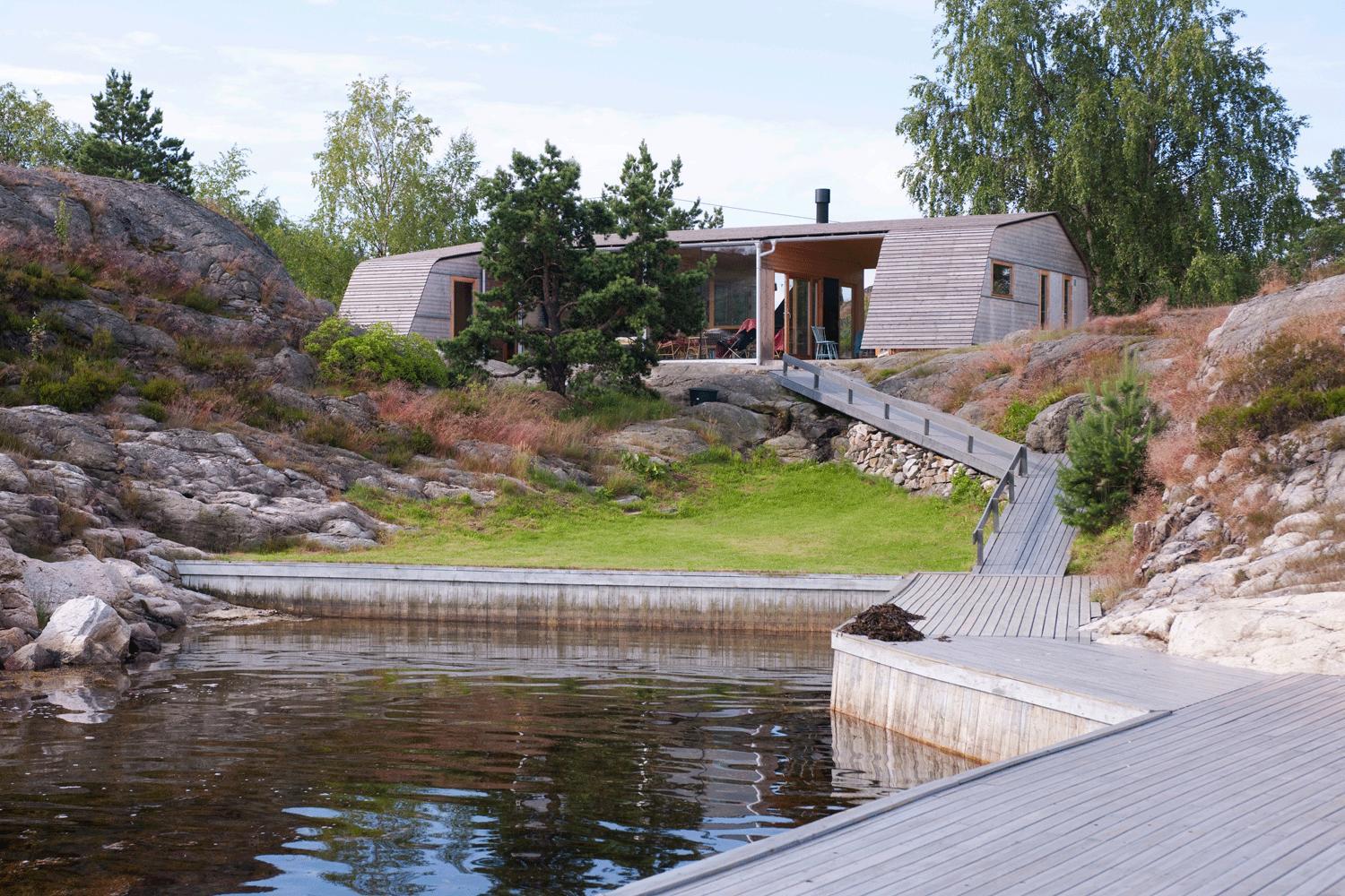 A modern cabin and a pond
