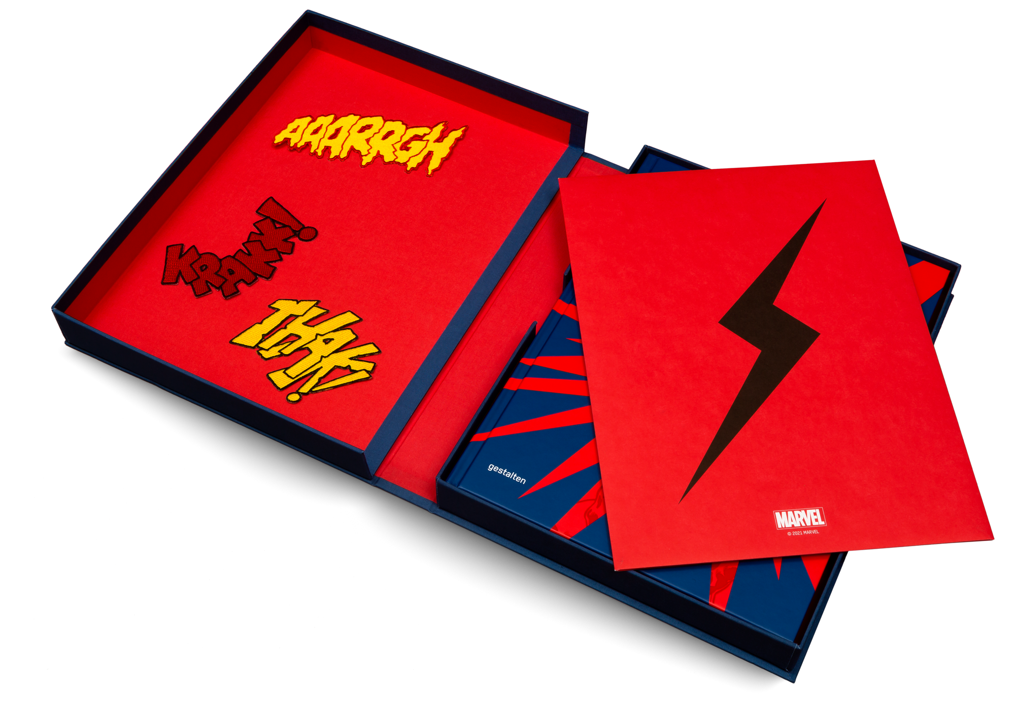 The linen bound presentation box contains three patches, three screenprints and a special edition of Marvel By Design