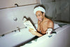 Raven Smith reading a book in his bath in How to be a Tastemaker.