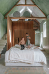 These two children enjoy this extraordinary revived barn with floating volumes and minimalist lines featured in Inspiring Family Homes by MilK Magazine and gestalten
